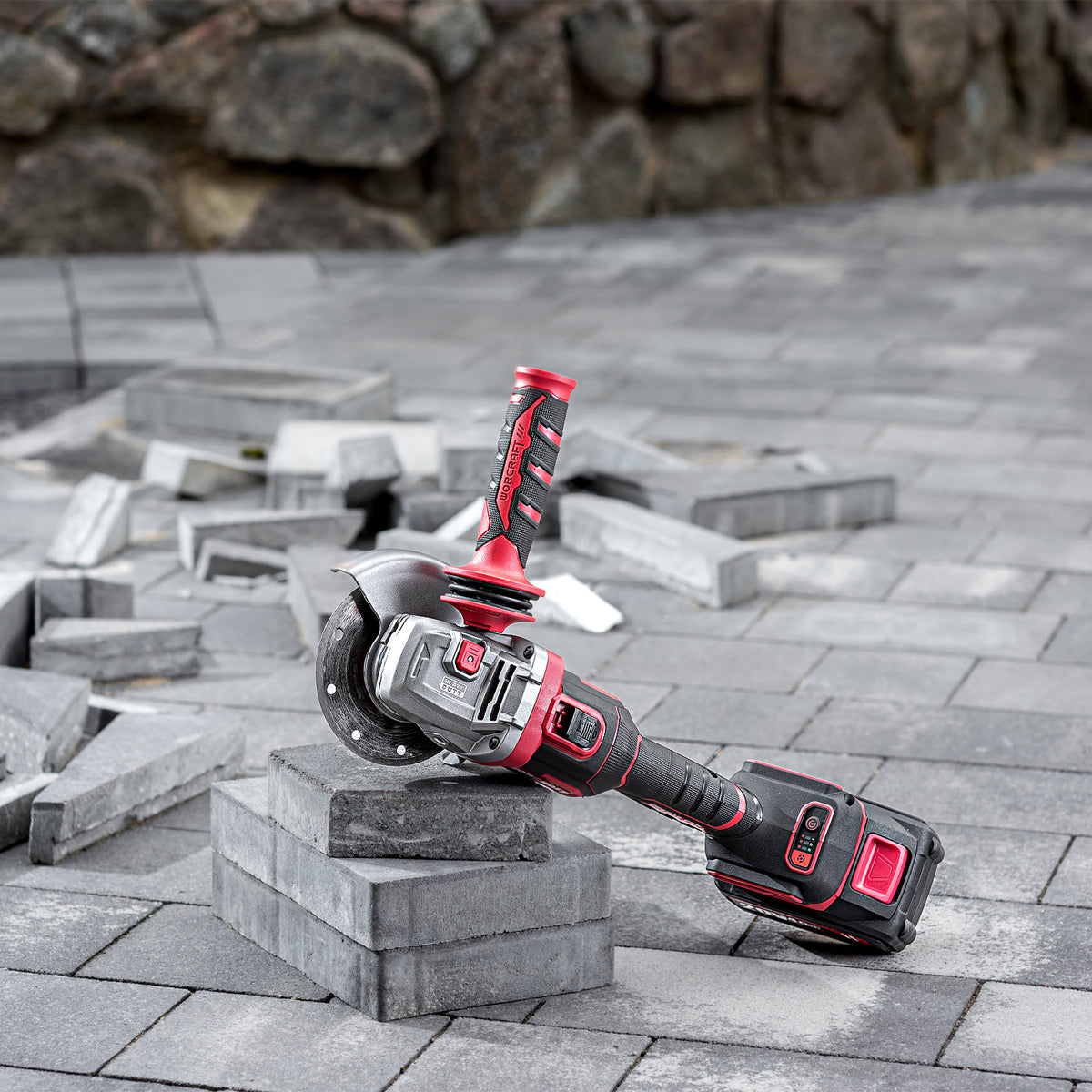 Worcraft angle grinder in use on concrete tile pavers