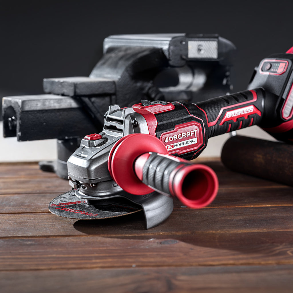 Worcraft brushless angle grinder with handle in use on wood planks