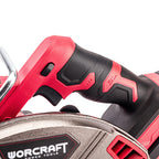 Close-up of a red and black cordless circular saw handle with the WORCRAFT logo visible on the blade guard, set against a clean white background.