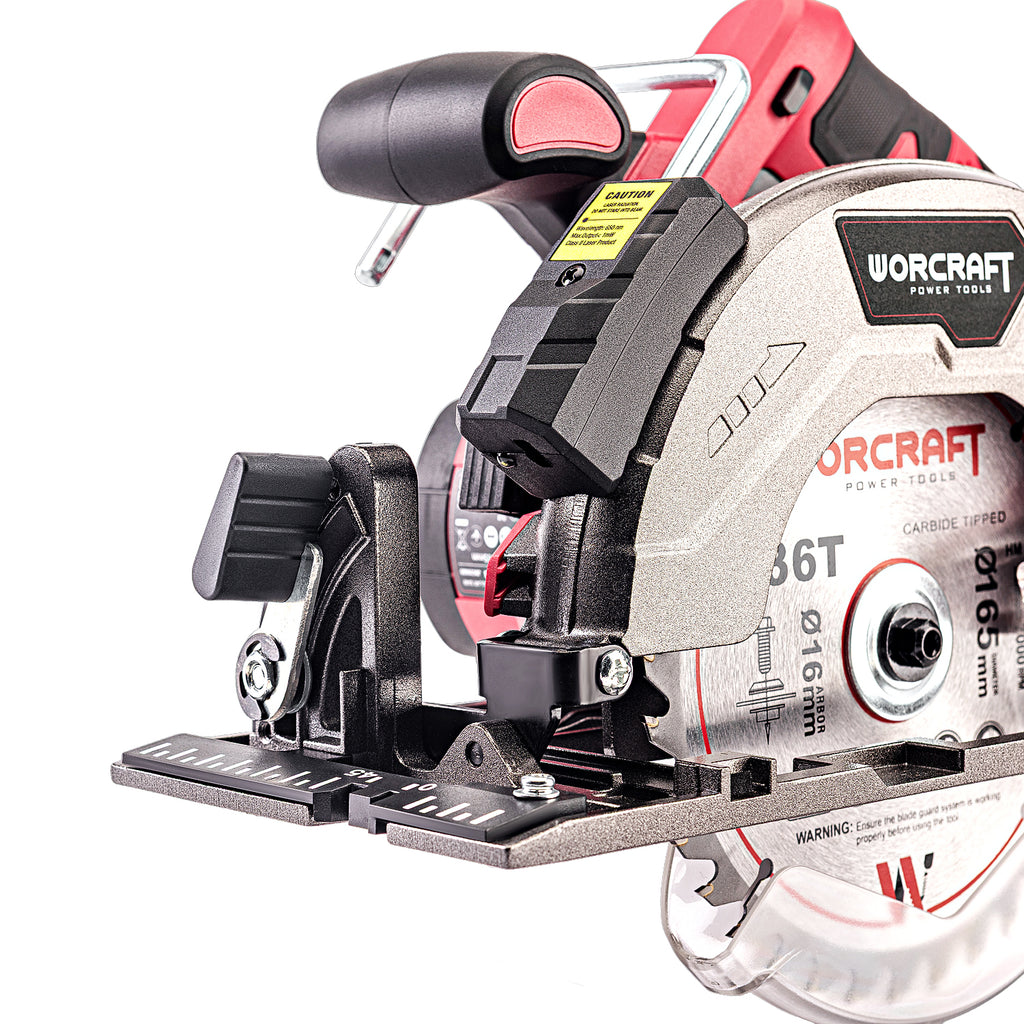 A close-up studio shot of a circular saw blade and baseplate assembly for a cordless circular saw, showing the silver carbide-lip blade, black and red handle components, and visible WORCRAFT branding on the housing.