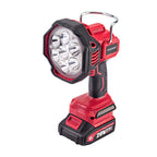 A Worcraft cordless work light with a red and black body, featuring a clear protective lens over multiple LED bulbs, a metal hanging loop, and a battery pack at the base, shown on a solid white background.