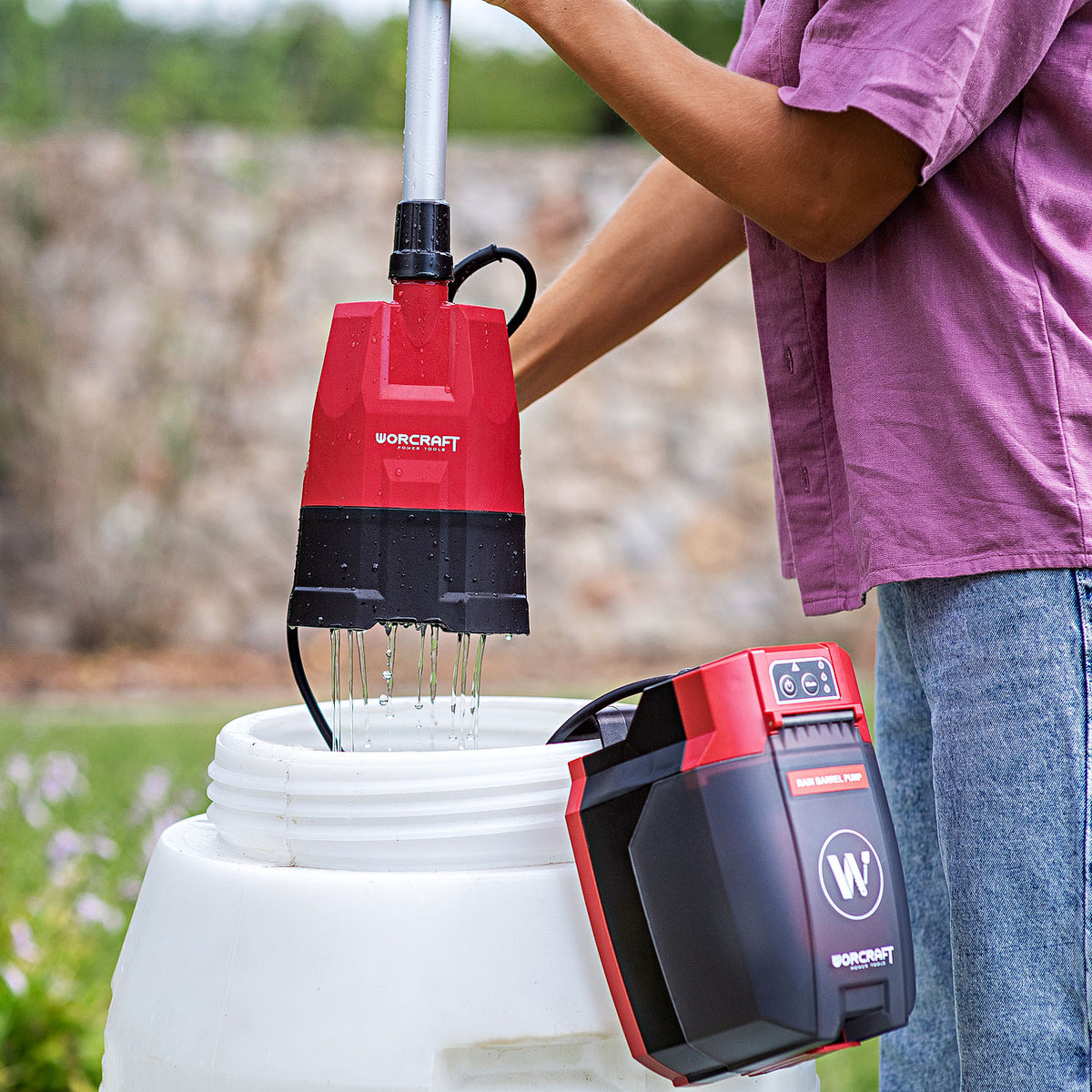Person using Worcraft cordless rain barrel pump to water garden