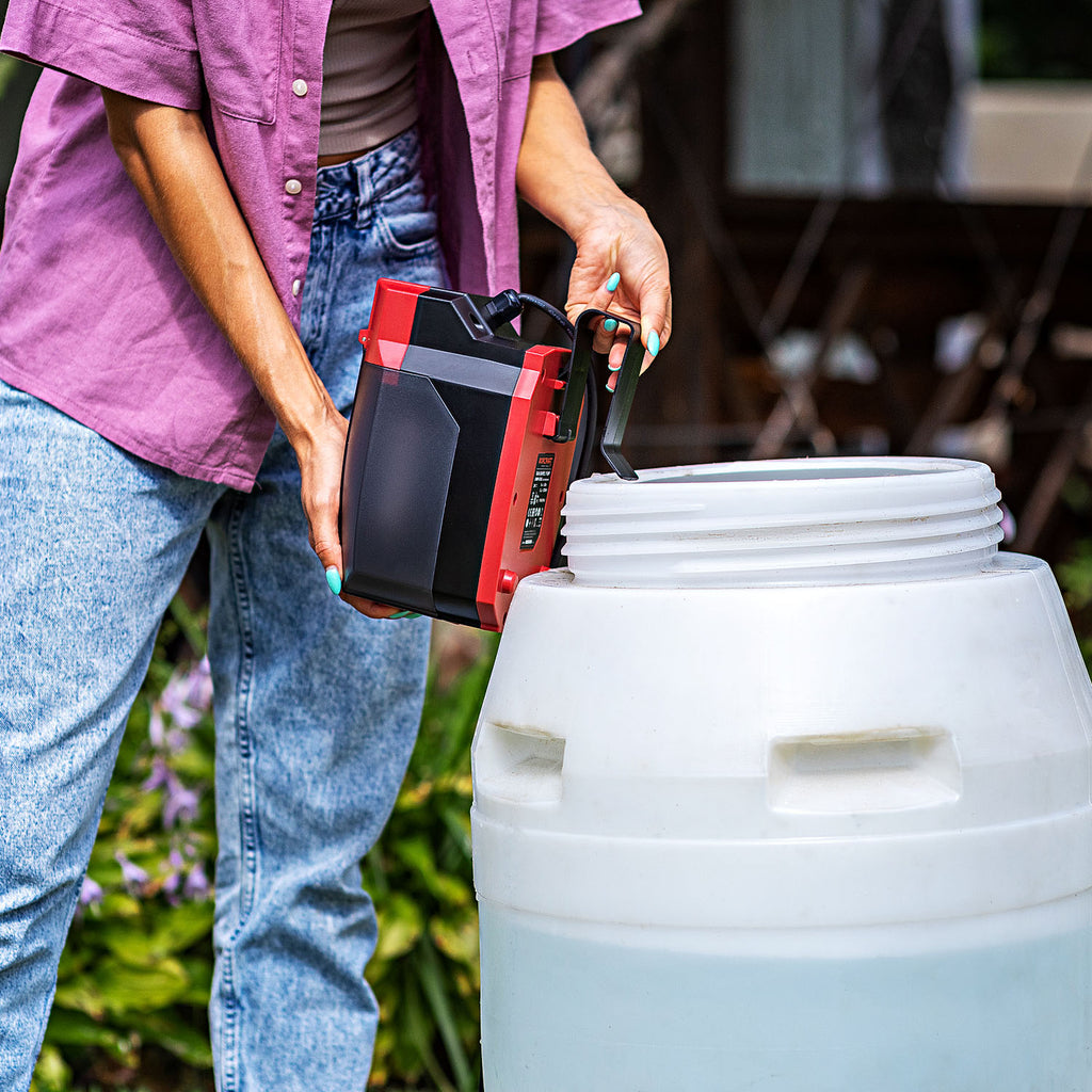 Person using their Worcraft cordless rain barrel pump