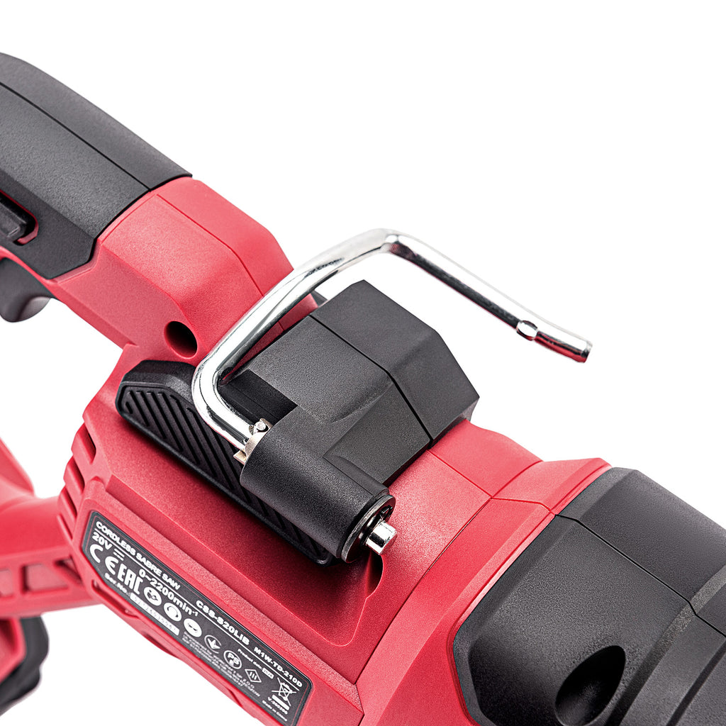 Close-up of a red and black cordless power tool showing a black plastic latch with a silver metal hook on top, photographed on a white background.