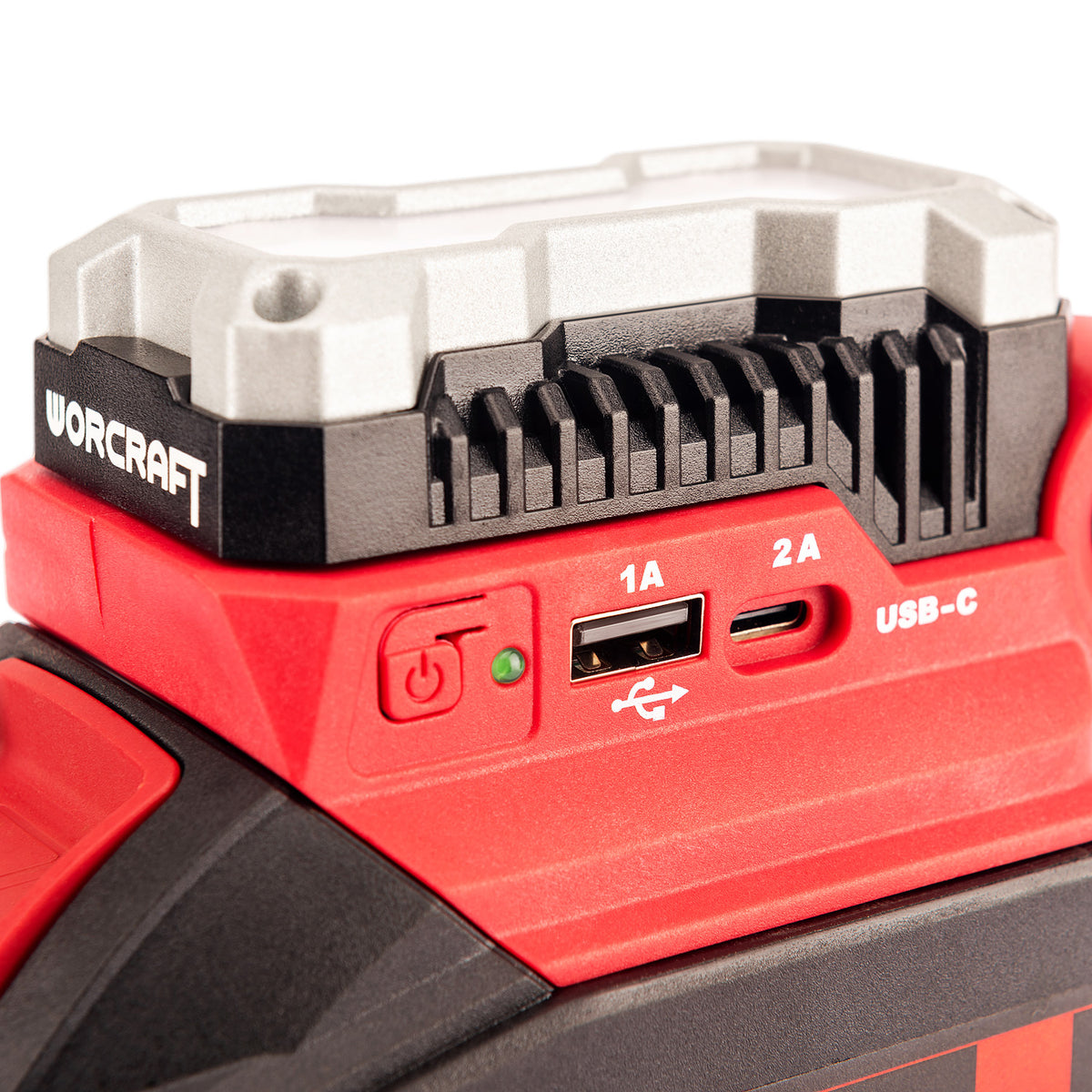 Close-up of a red and black WORCRAFT power tool showing USB-C and USB-A charging ports on the side, with a white and black mounting plate on top.