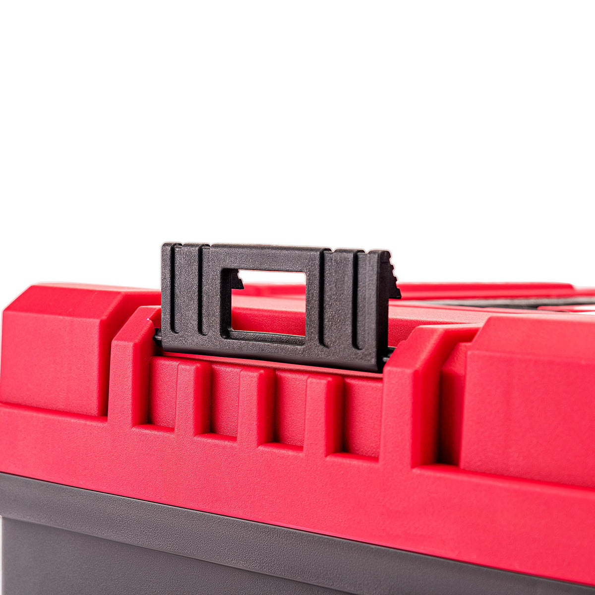 Close-up of a red plastic toolbox with a black handle latch on a white background.