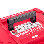 A close-up of a red plastic toolbox lid with a black handle. The lid has large white 'WORCRAFT POWER TOOLS' branding and a white product label showing the model XCUBE001 and tool icons.