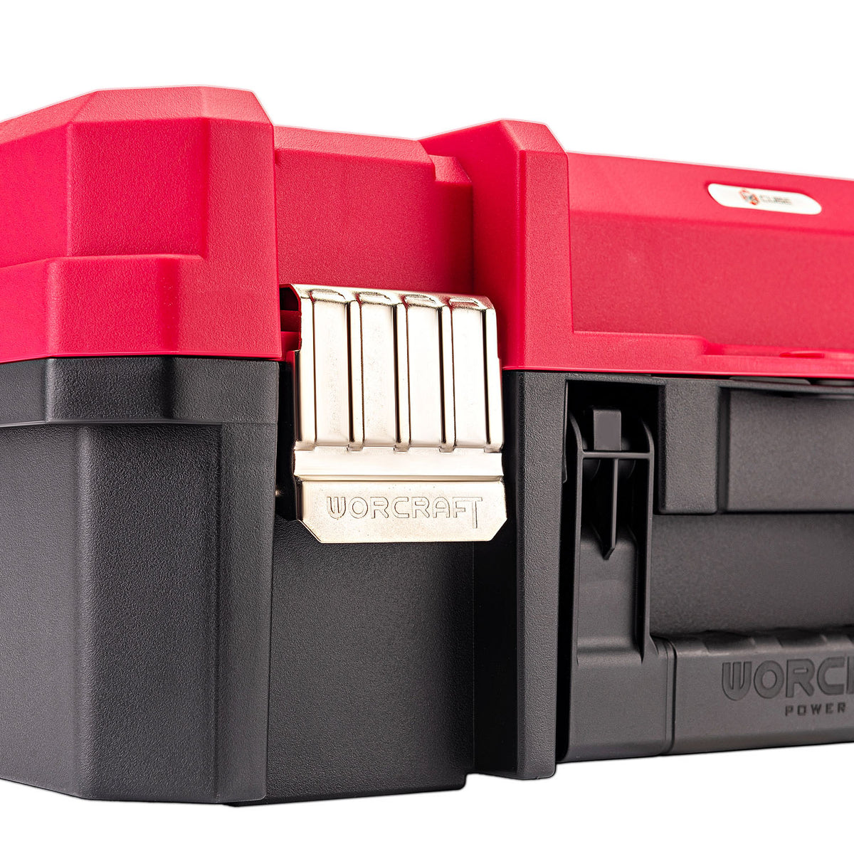 Close-up of a red and black plastic tool box with a silver metal latch, showing the WORCRAFT brand name on the latch and side.