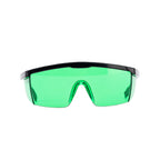 Shield-style safety glasses with a thick green-tinted lens and a black frame, shown against a plain white background.