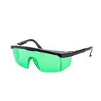Shield-style safety glasses with a black frame and bright green tinted lenses, shown on a plain white background.