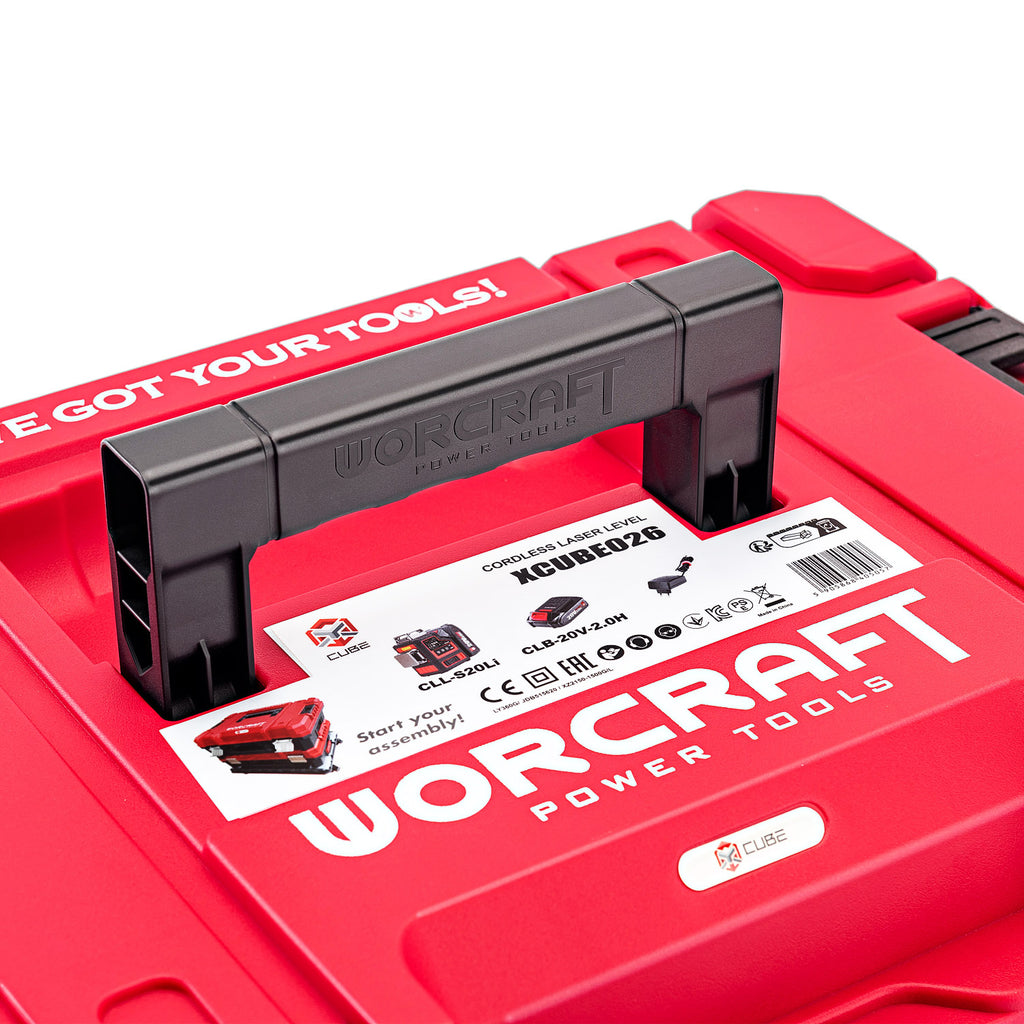 Close-up of a red Worcraft power tools carrying case with a black handle and a white product label on top, photographed on a white background.