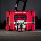 A red Worcraft XCUBE laser level kit with two red and black laser units in front of a matching red carrying case, set against a dark gray background with green laser lines projected on the floor.
