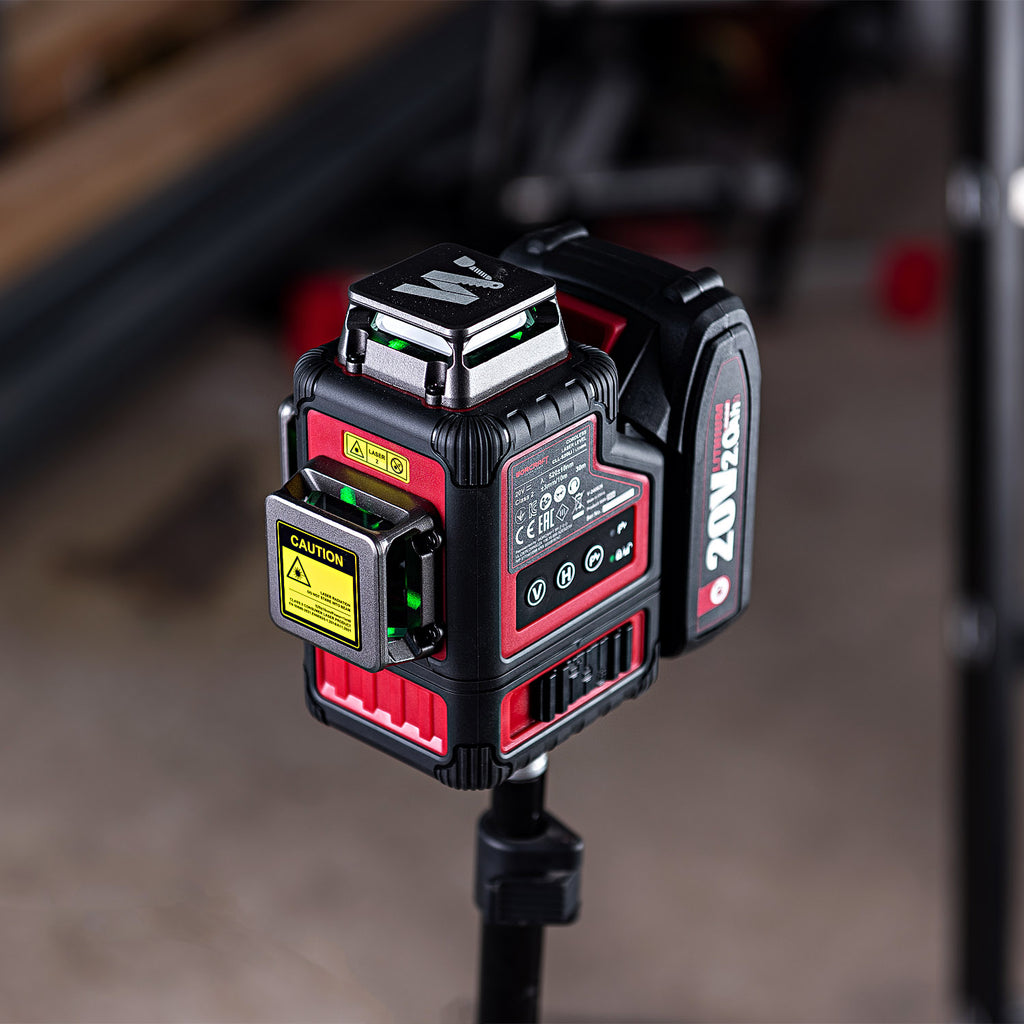 A red and black 20V MAX laser level mounted on a black tripod stand, photographed in a workshop environment with a blurred background.