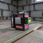 A WORCRAFT 20V 4S laser level standing on wooden planks in a construction setting, with green laser lines projected on the floor and a blurred brick wall in the background.