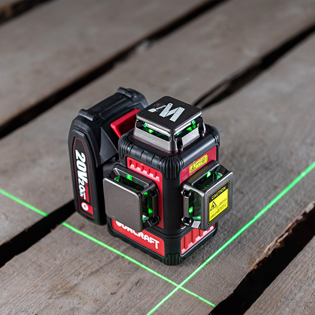 A red and black laser level device with green laser lines projected on a weathered wooden plank surface. The device has visible brand markings including 'Worcraft' and '20M'.